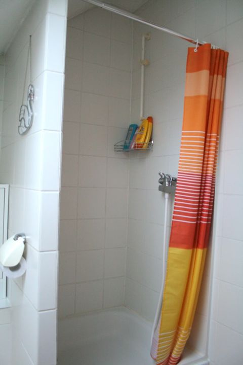 Bad: Dusche mit buntem Duschvorhang